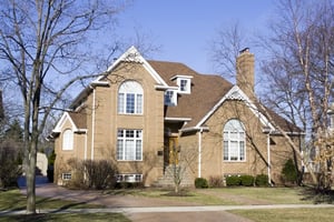 Cleaning roof tiles and exterior walls using pressure washing, representing roof and wall cleaning before coating for long-term protection.