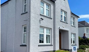 Exterior wall coatings applied to a Scottish home to improve the appearance and protect the textured exterior walls.