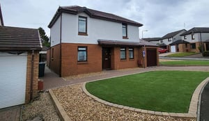 Wall refurbishment work being carried out by a professional to repair and improve an external wall surface.