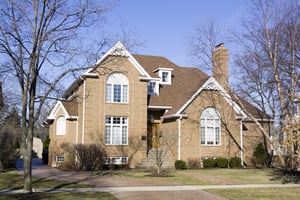 Cleaning roof tiles and exterior walls using pressure washing, representing roof and wall cleaning before coating for long-term protection.