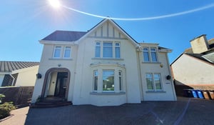 Wall refurbishment and re-rendering on a Scottish property with a light exterior finish and a well-maintained roof.