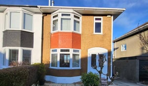 Wall refurbishment on a Scottish home featuring a refreshed terracotta and white exterior finish.