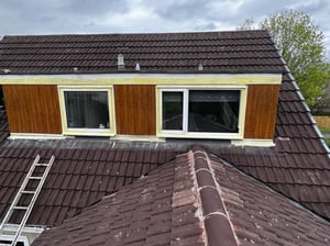 Roof tile water absorption visible on weathered roof tiles of a Scottish home.